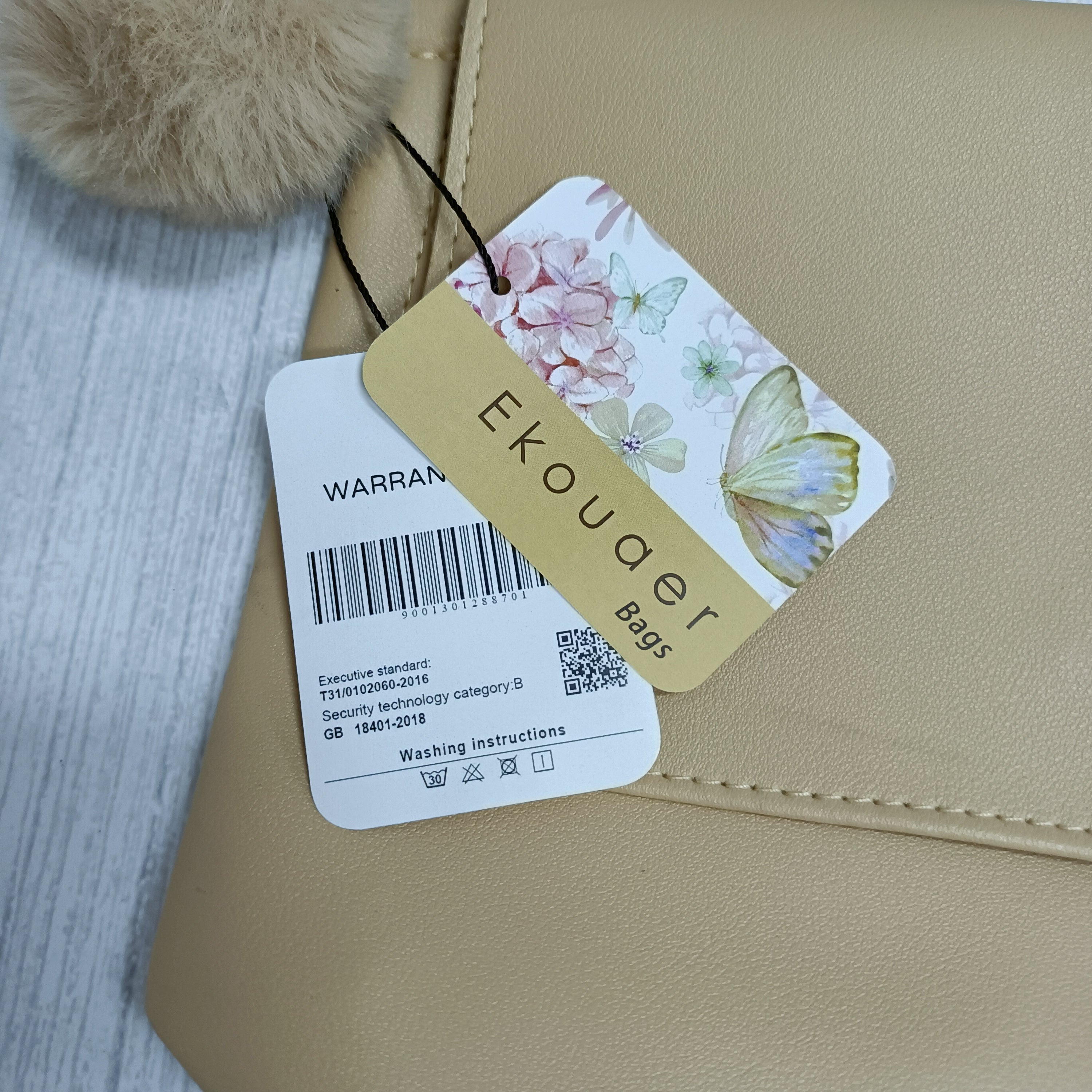 Ekouaer crossbody bag close-up with floral tag attached to the flap