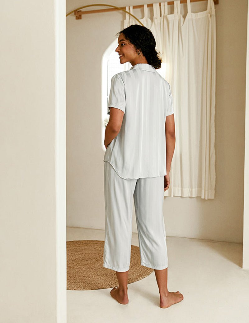 Grey silk satin pajama set with short-sleeve button shirt and cropped pants, back