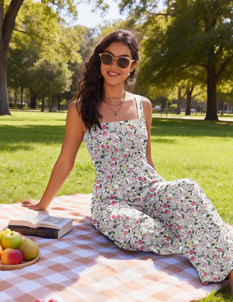 Floral wide-leg jumpsuit with spaghetti straps, worn on a picnic blanket