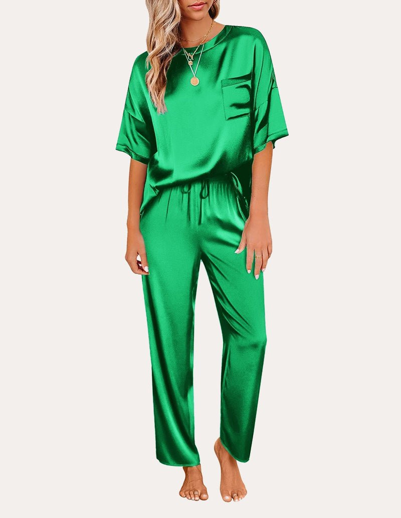 Green satin pajama set with short sleeves: chest pocket top and drawstring waist lounge pants.