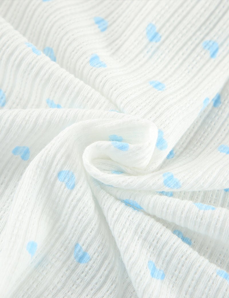 White knit fabric with light-blue dot pattern, soft textured weave