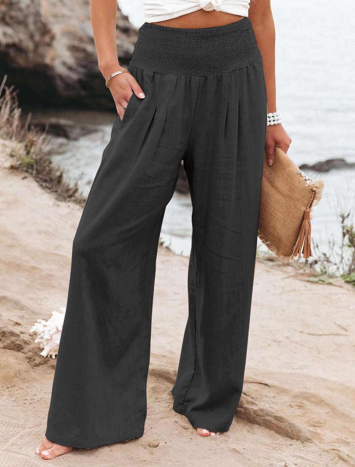Black cotton wide-leg lounge pants with elastic smocked waistband and pleated legs