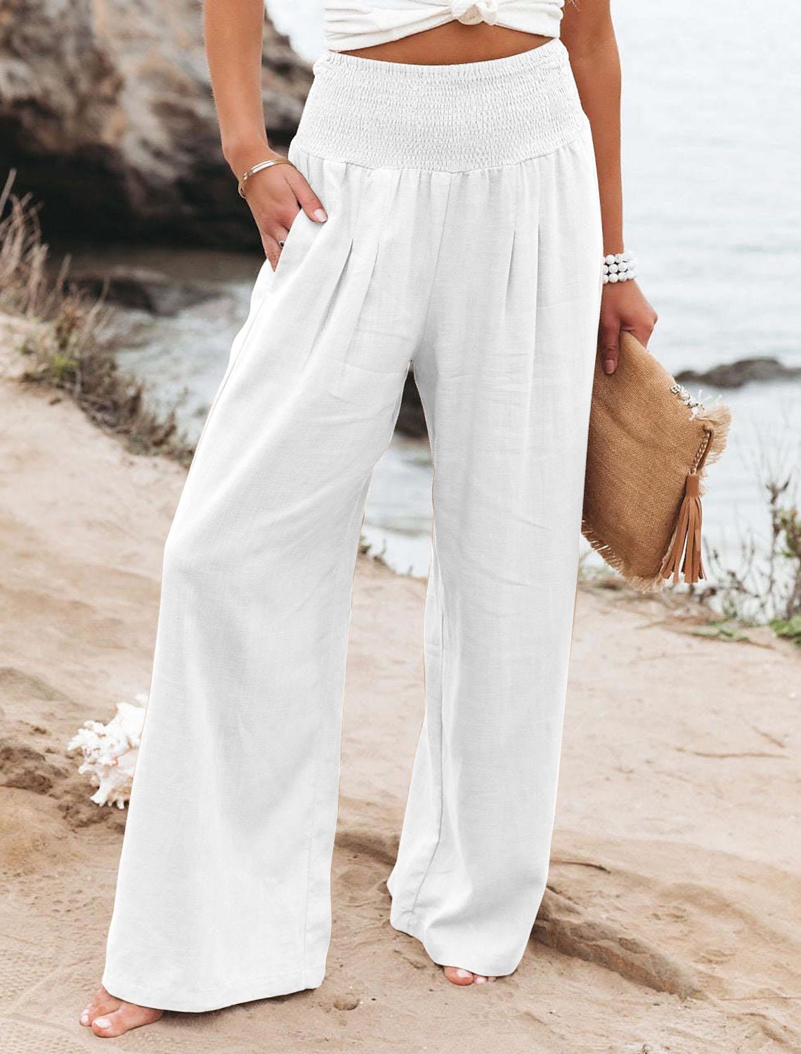 White cotton wide-leg lounge pants with elastic smocked waistband and pleated front