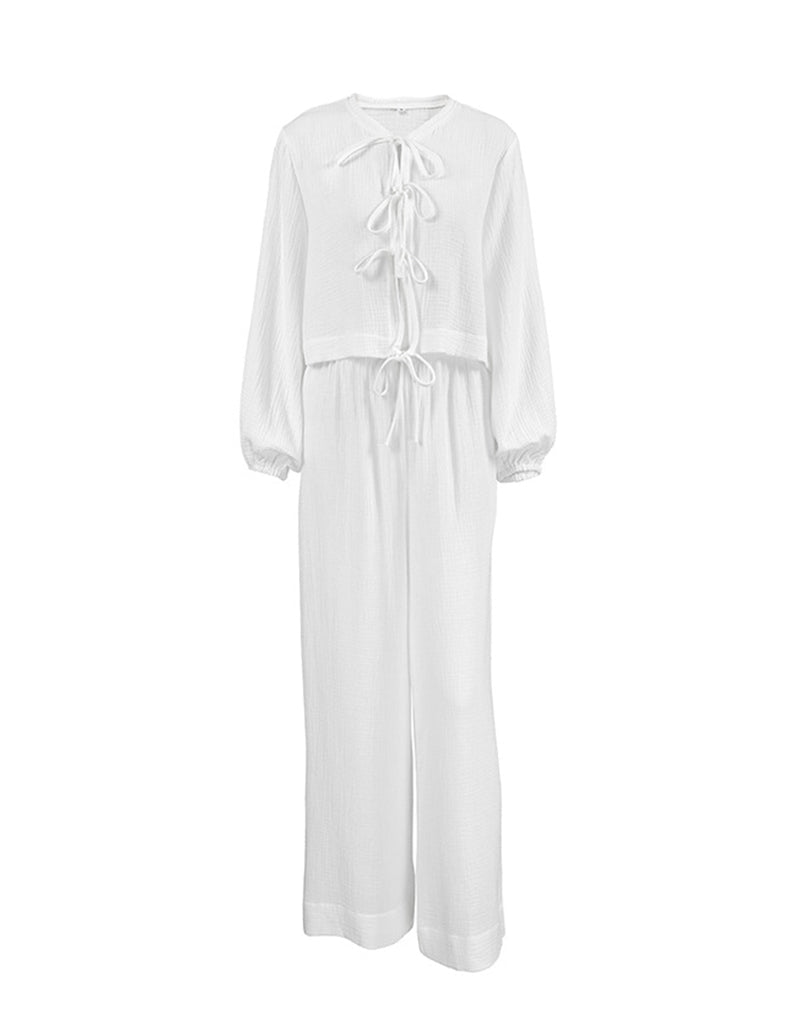 White cotton lounge set with drawstring top and matching wide-leg pants, studio view