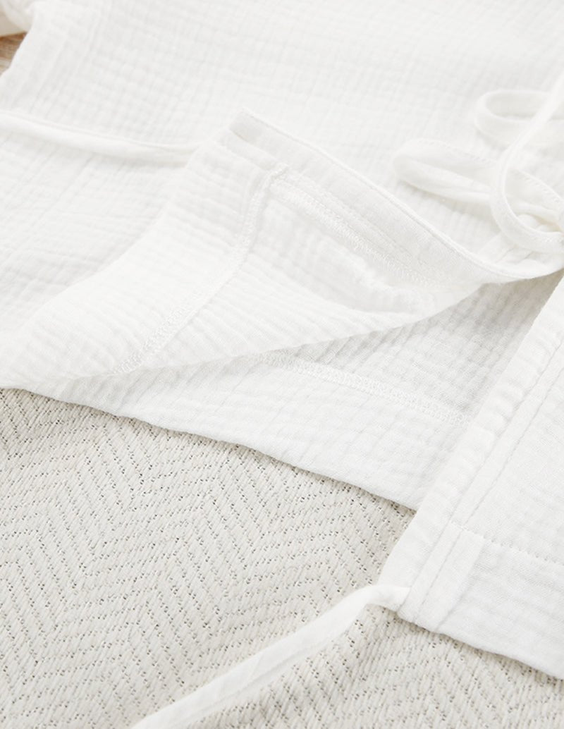 White cotton lounge pants with elastic waist and relaxed drape