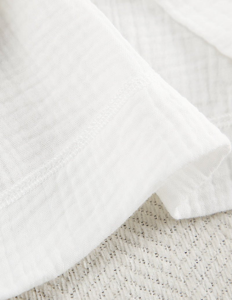 White cotton lounge fabric close-up with subtle textured weave