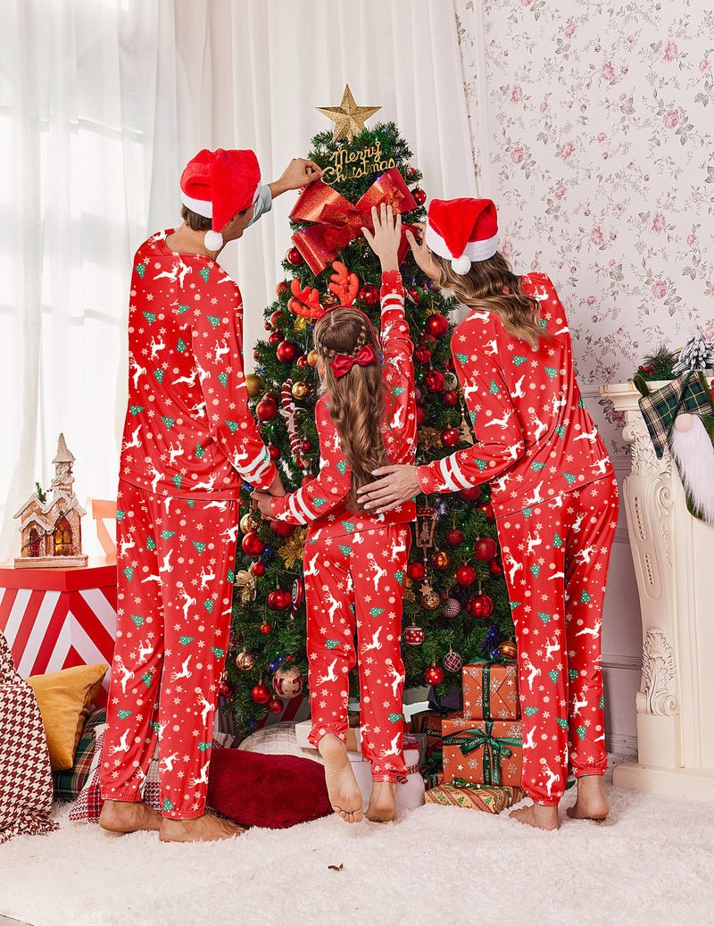 Family Christmas pajama set in red all-over print, Santa hats on three people