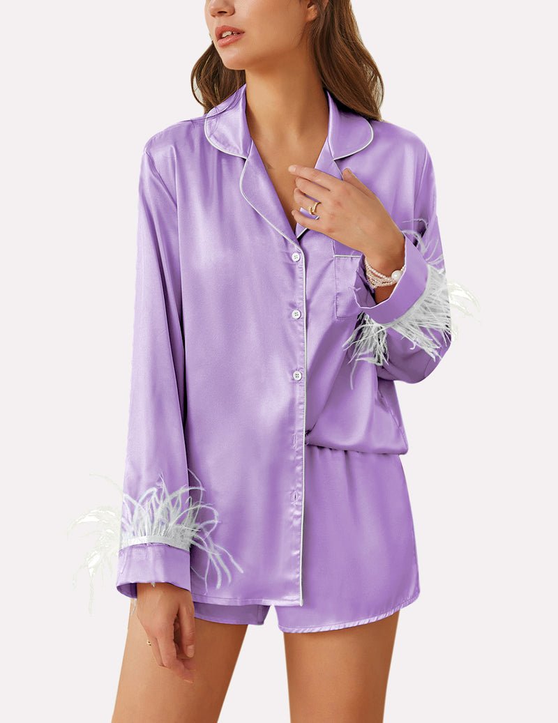 Lavender satin pajama set with feather-trim cuffs and button front top, matching shorts.