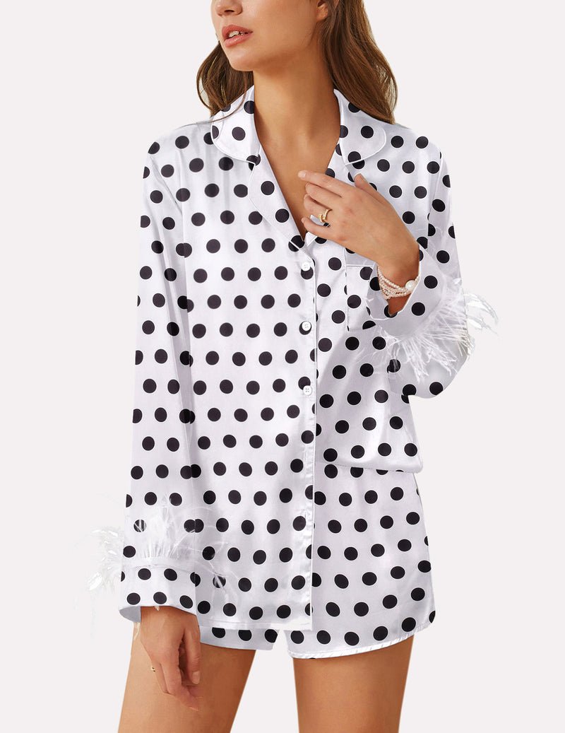 White satin pajama set with black polka dots, feather-trim cuffs, button front top.