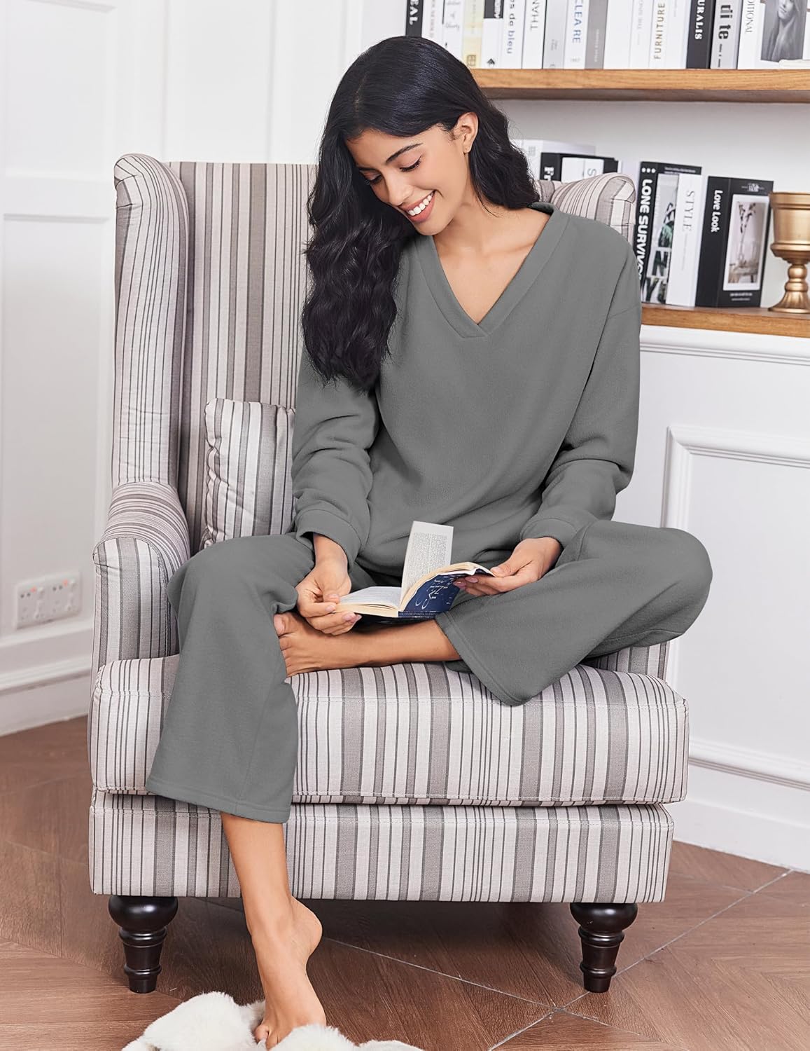Gray fleece lounge set, V-neck long sleeves and relaxed pants, sitting on sofa