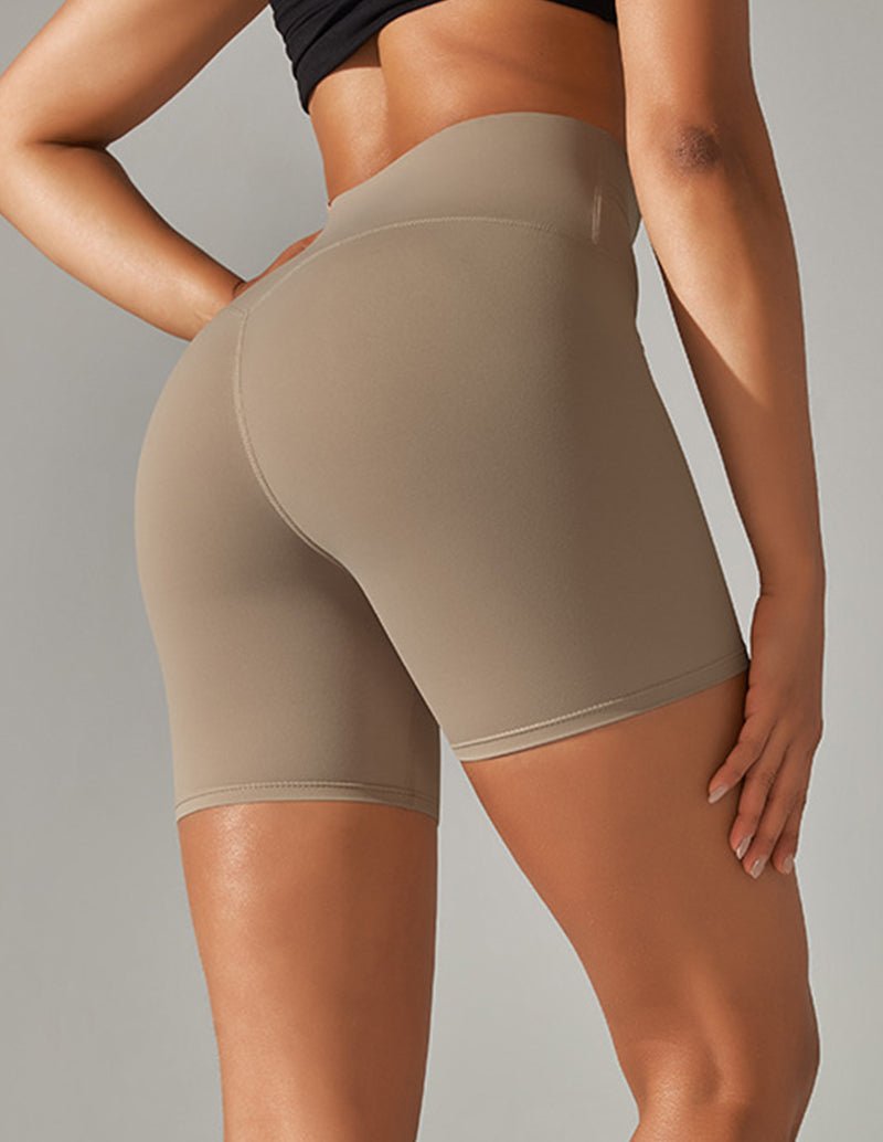 Beige high-waist stretch yoga shorts, angled front view