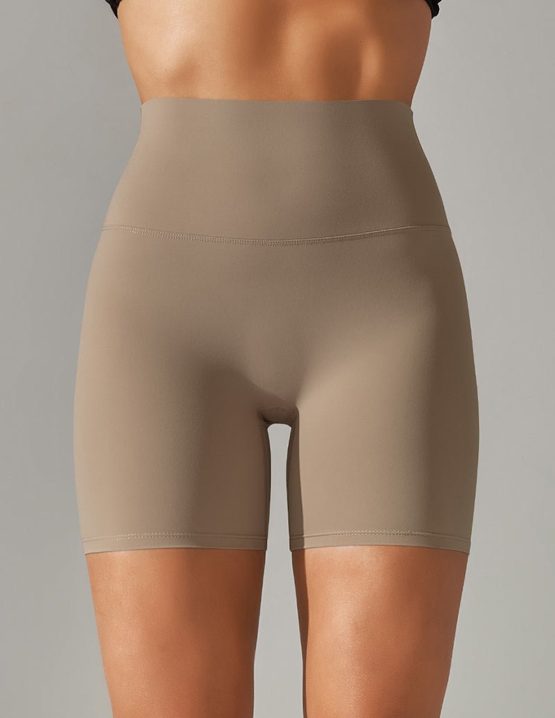 Beige high-waist stretch yoga shorts with centered front seam