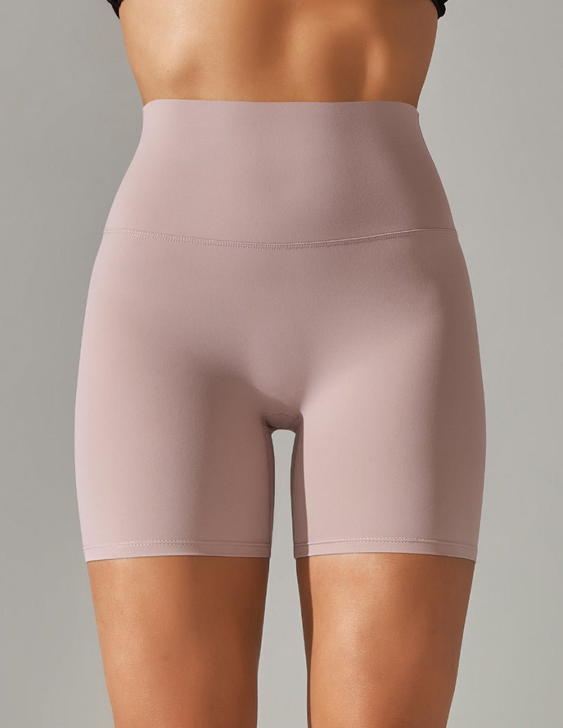 High waist stretch yoga shorts, light pink, fitted with wide waistband and seam.