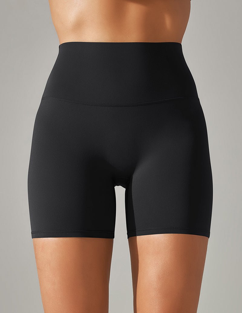 High-waisted stretch yoga shorts in black, mid-thigh length.