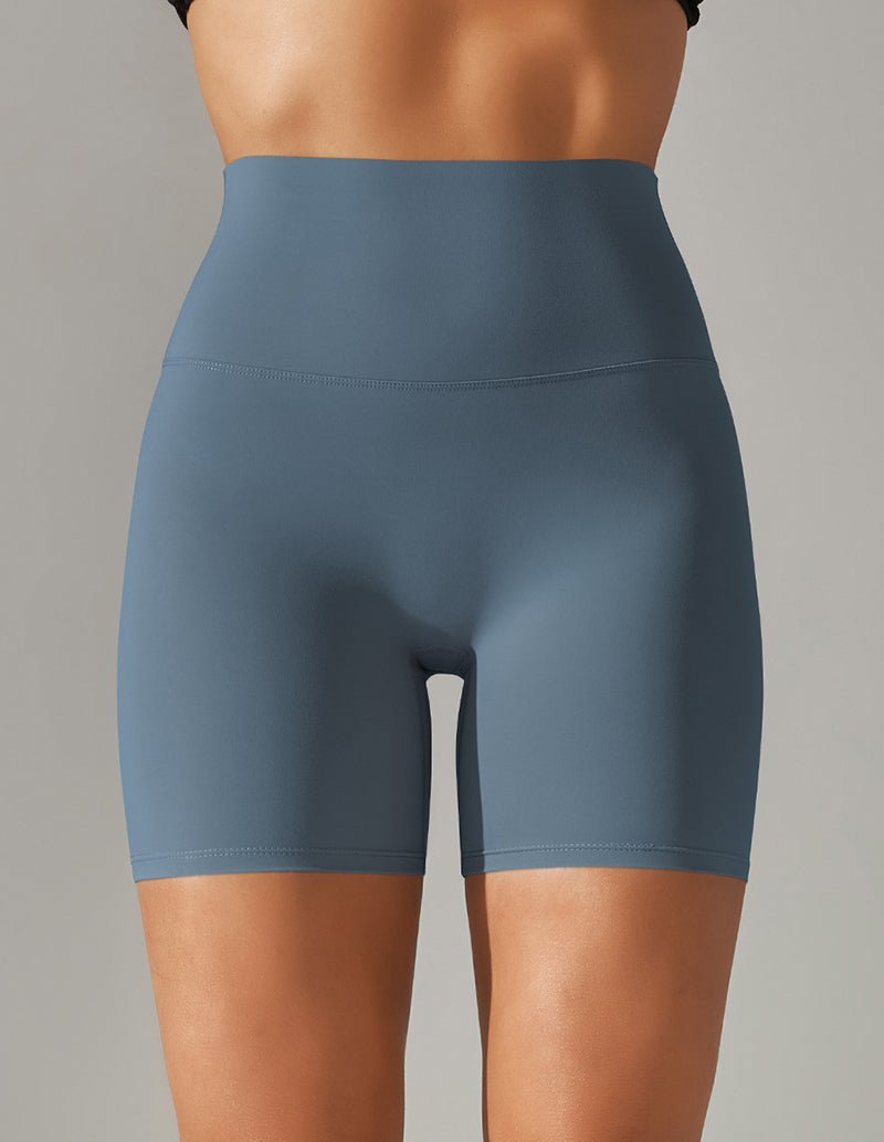 High-waisted stretch yoga shorts in blue, mid-thigh length.
