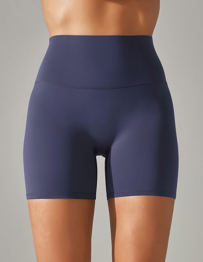 High-waisted stretch yoga shorts in dark purple, mid-thigh length.