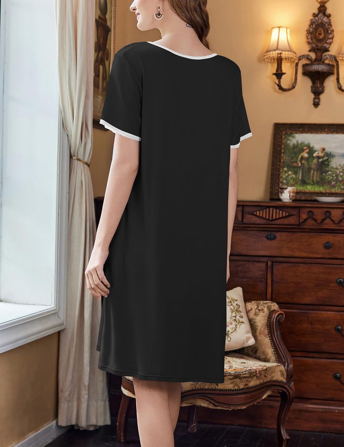 Black short-sleeve house dress, side view, simple round neckline and straight hem