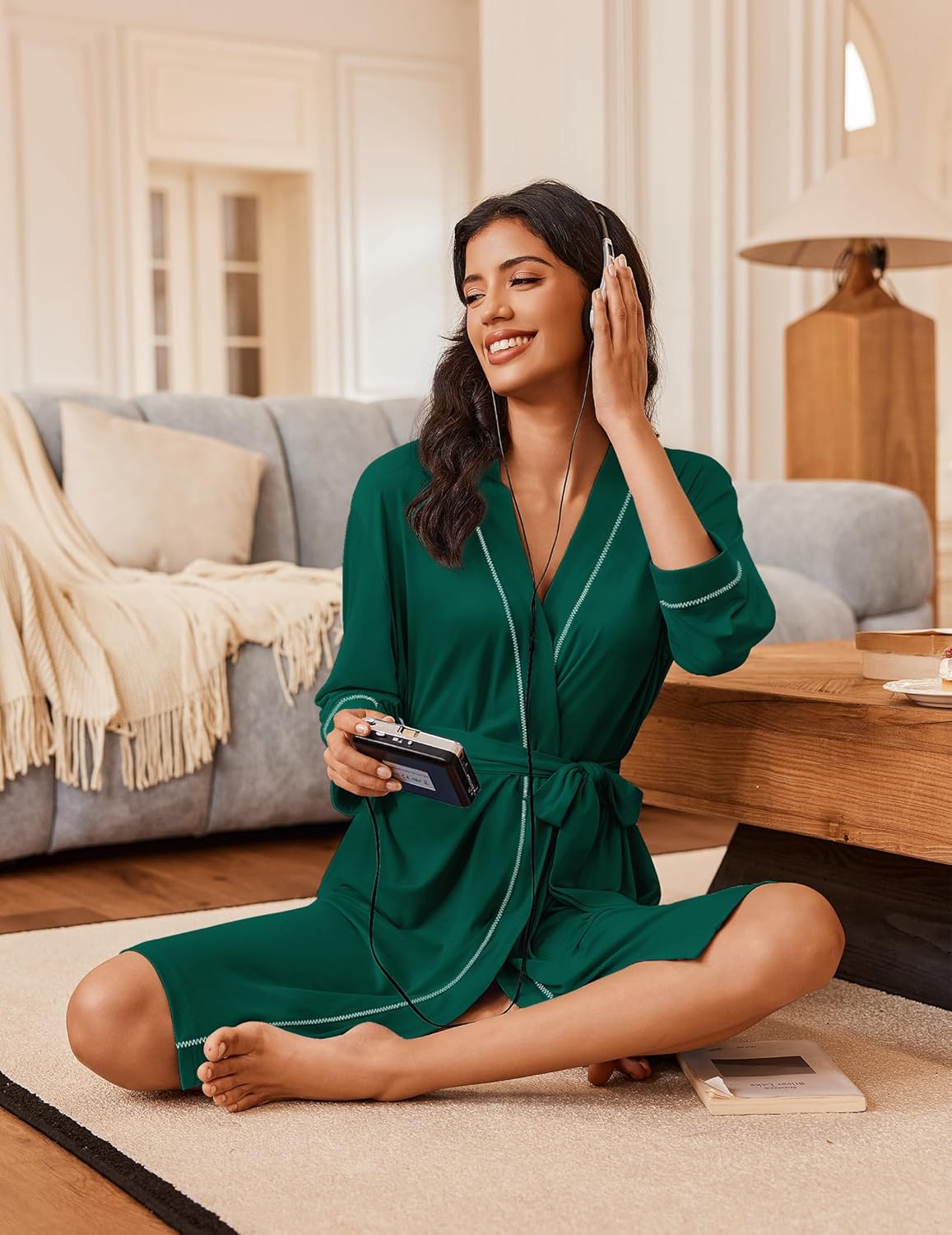 Dark green knee robe with 3/4 sleeves and tie belt, contrast trim; seated side view