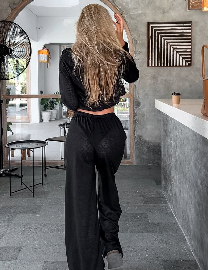 Black long lounge pants with elastic waist and loose wide legs