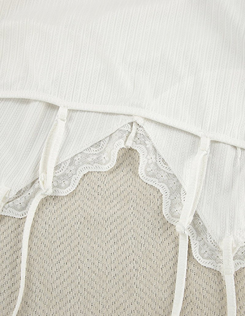 White knit pants with lace-trim side tie and scalloped waist panel