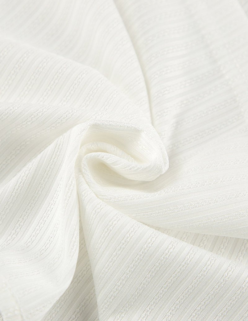 White knit fabric with soft drape and visible ribbed texture