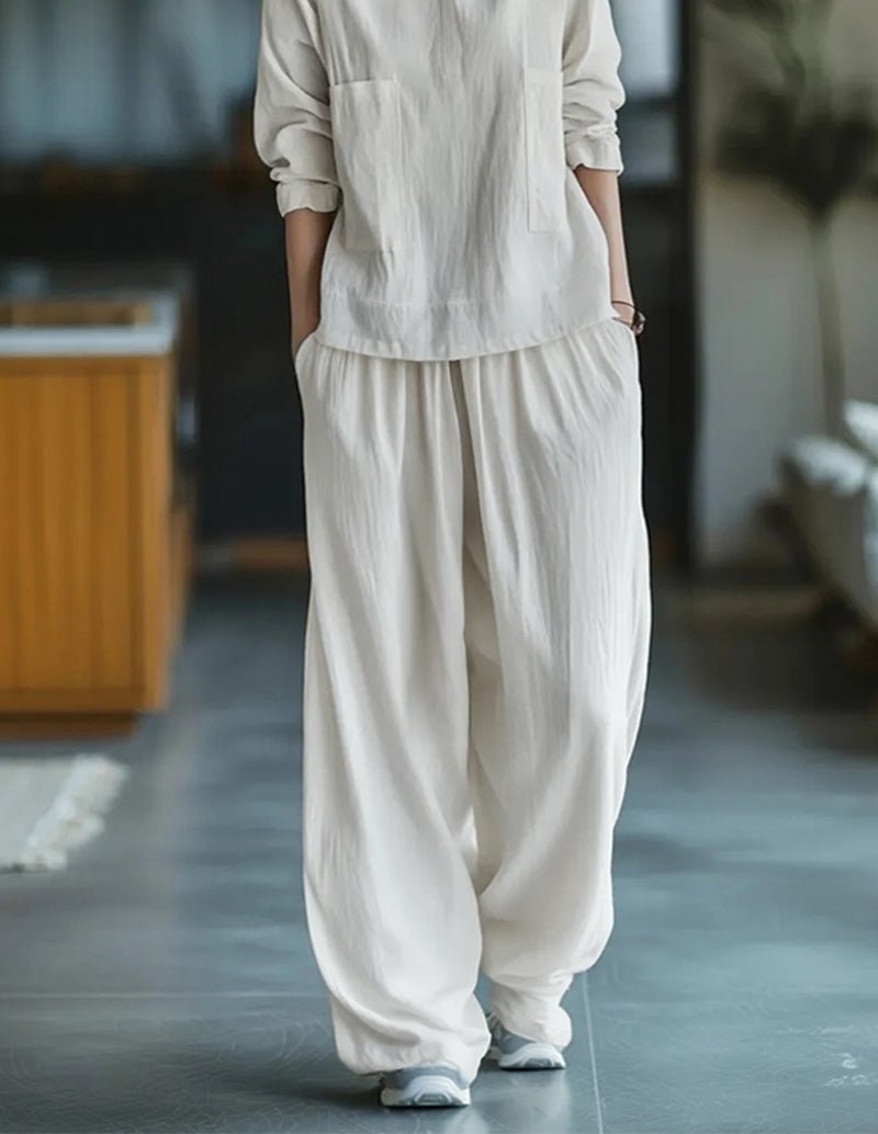 White cotton two-piece set with cuffed sleeves and relaxed jogger trousers