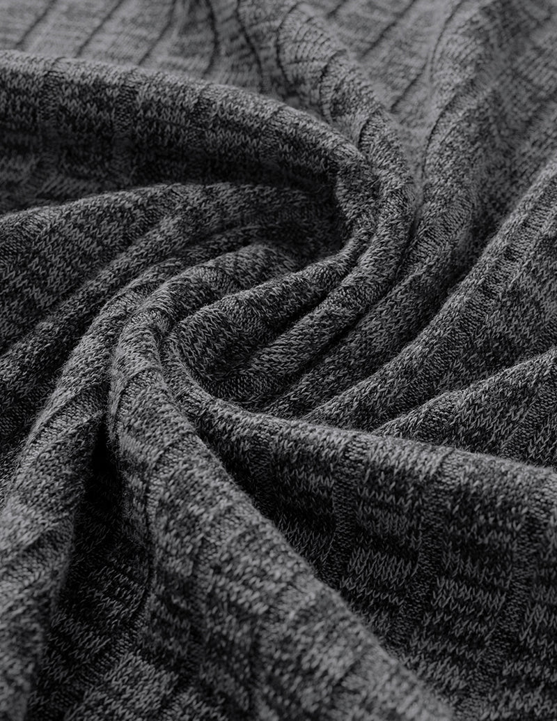 Close-up of dark grey ribbed knit fabric with textured swirl pattern