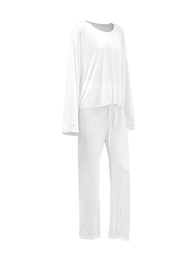 White knit loungewear set, long-sleeve top and drawstring pants laid flat