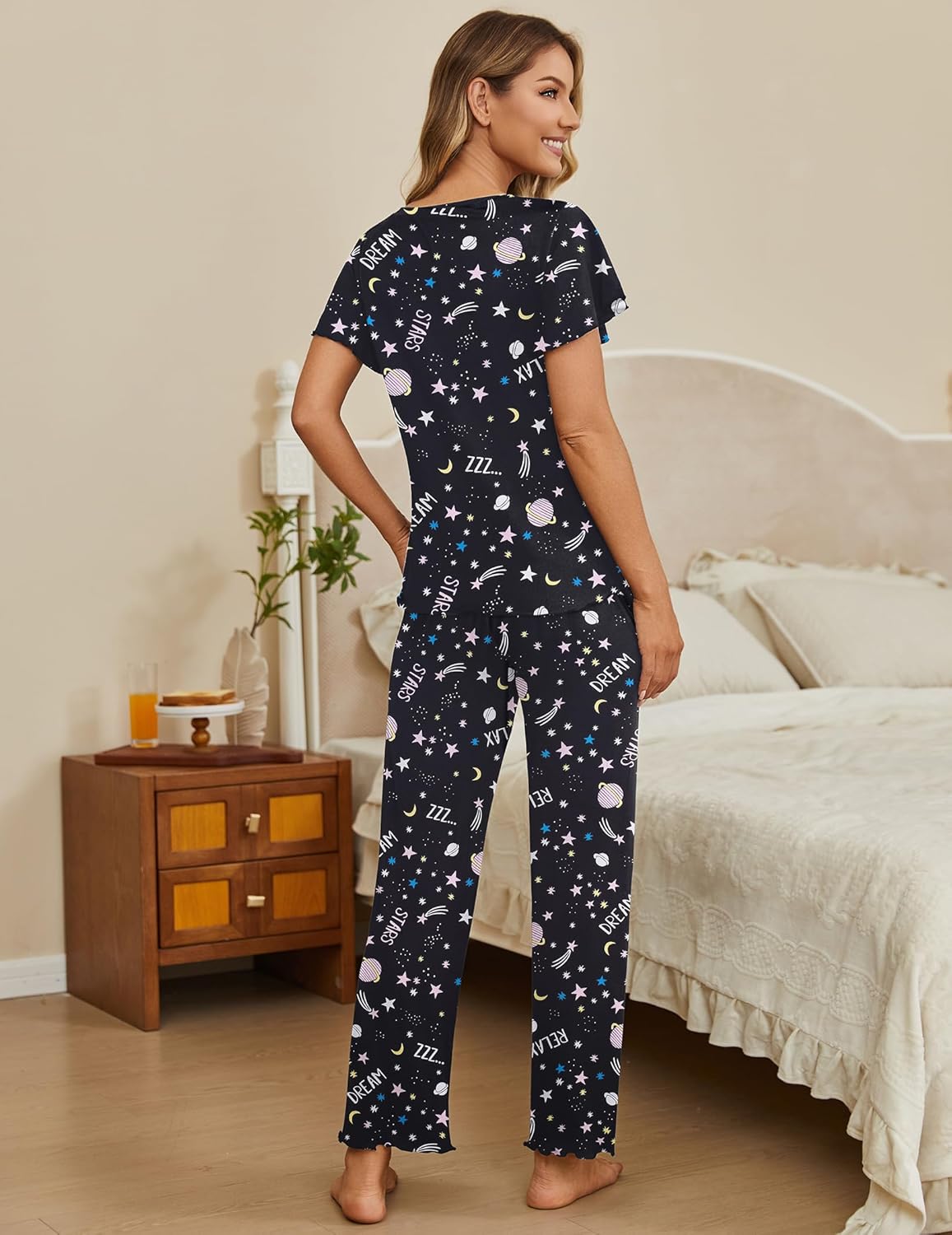 Two-piece lounge set with black starry V-neck top and matching long pajama pants