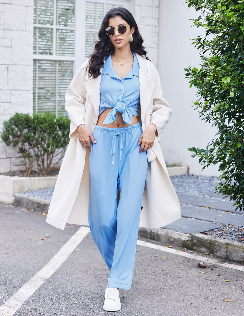 Light blue pajama set with button-front top and tied waist, matching wide pants