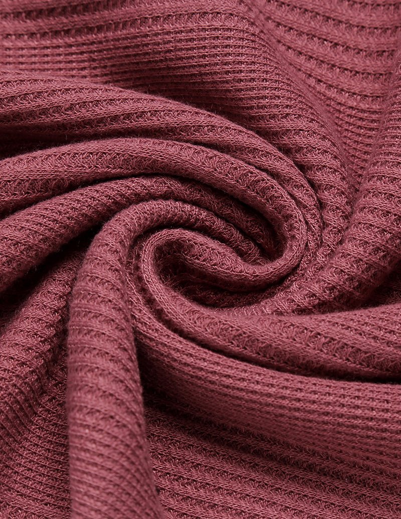 Maroon waffle-texture fabric, close-up of rolled edge and knit pattern