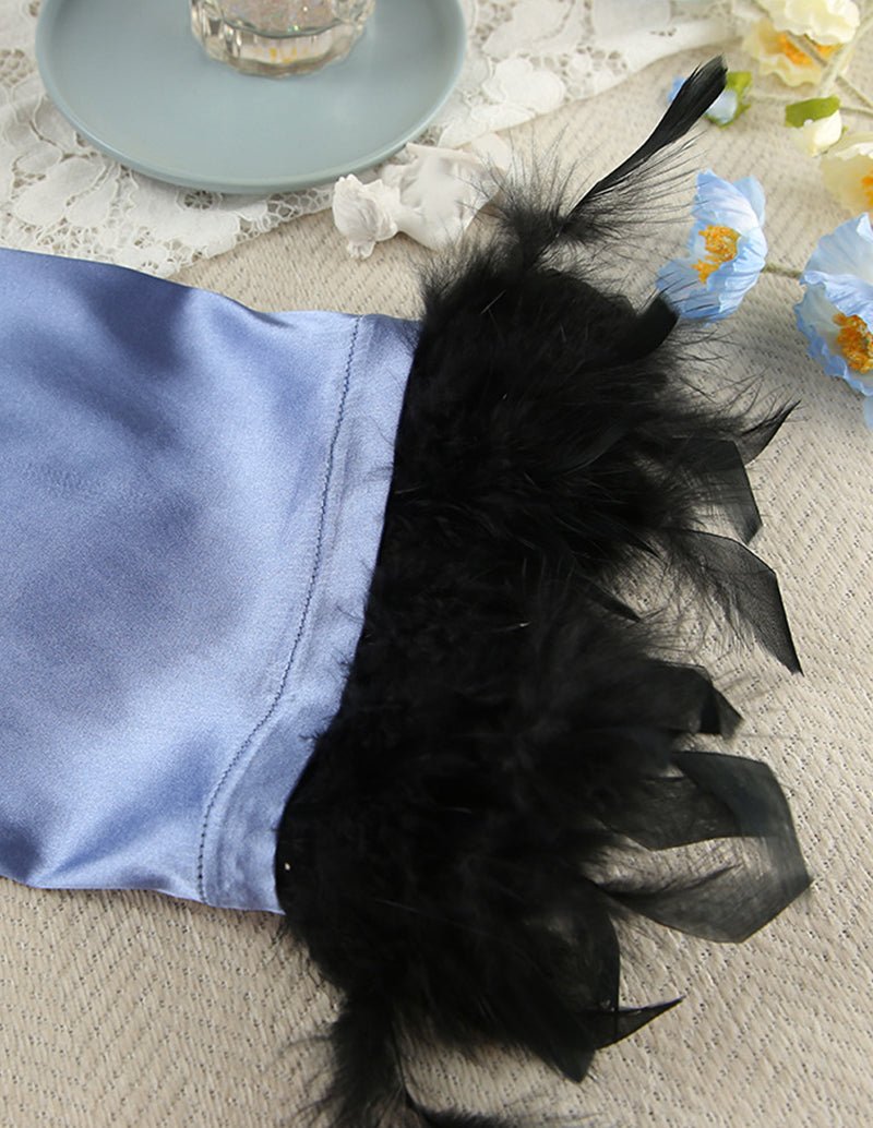 Blue satin pajama sleeve cuff with black feather patch detail
