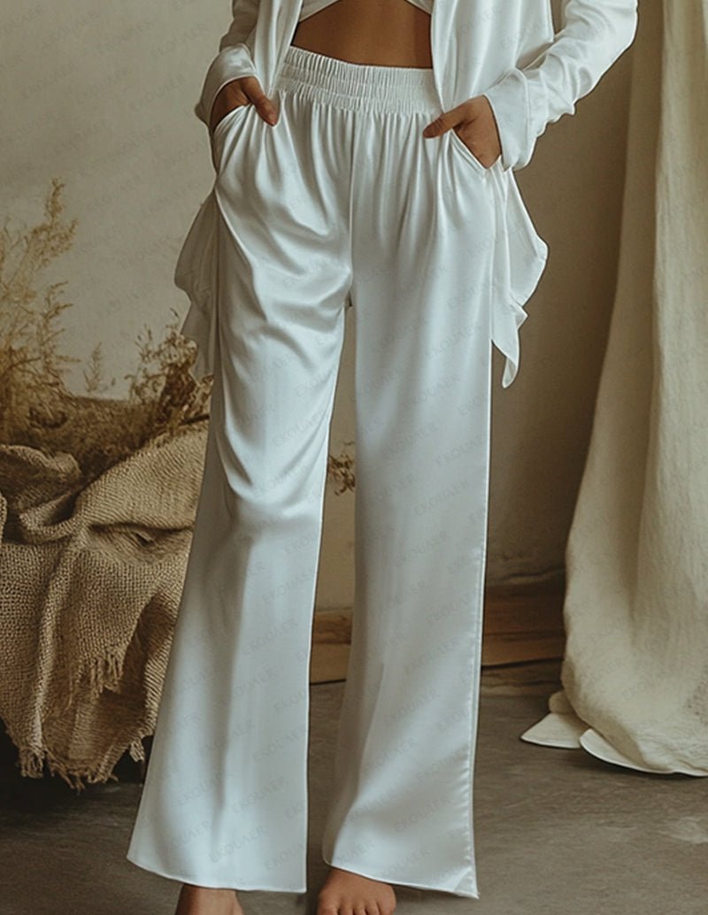 White satin wide-leg pants with elastic waistband and side tie, part of a lounge set