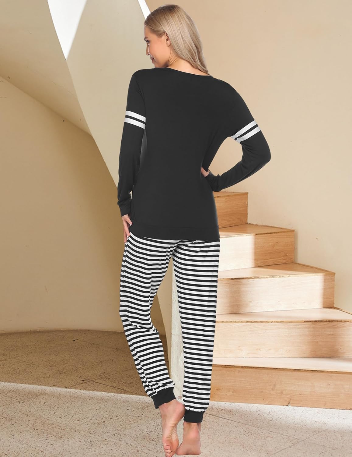 Maternity nursing pajama set back view: black top with stripe cuffs, striped pants