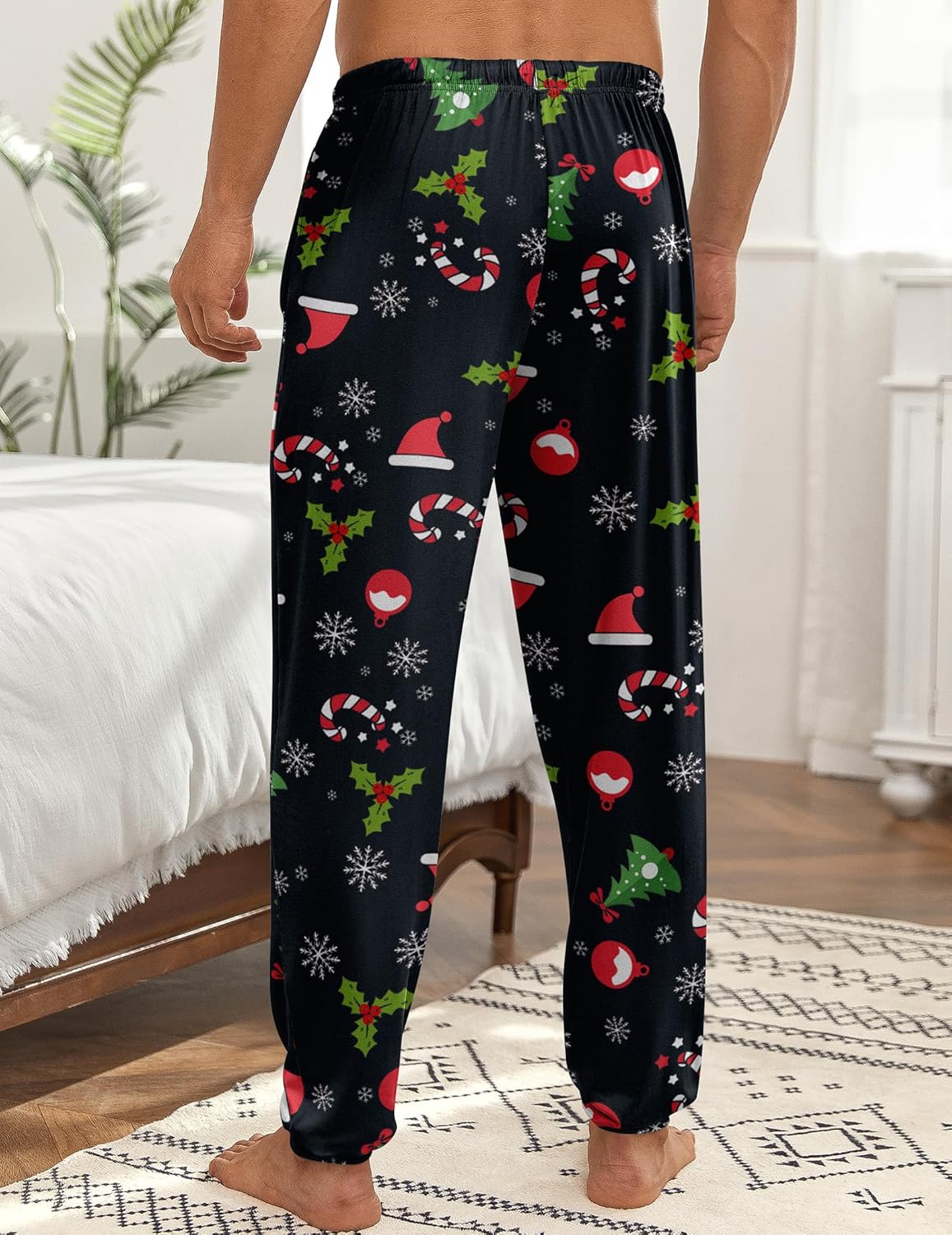 Men’s black holiday print pajama jogger pants with festive pattern