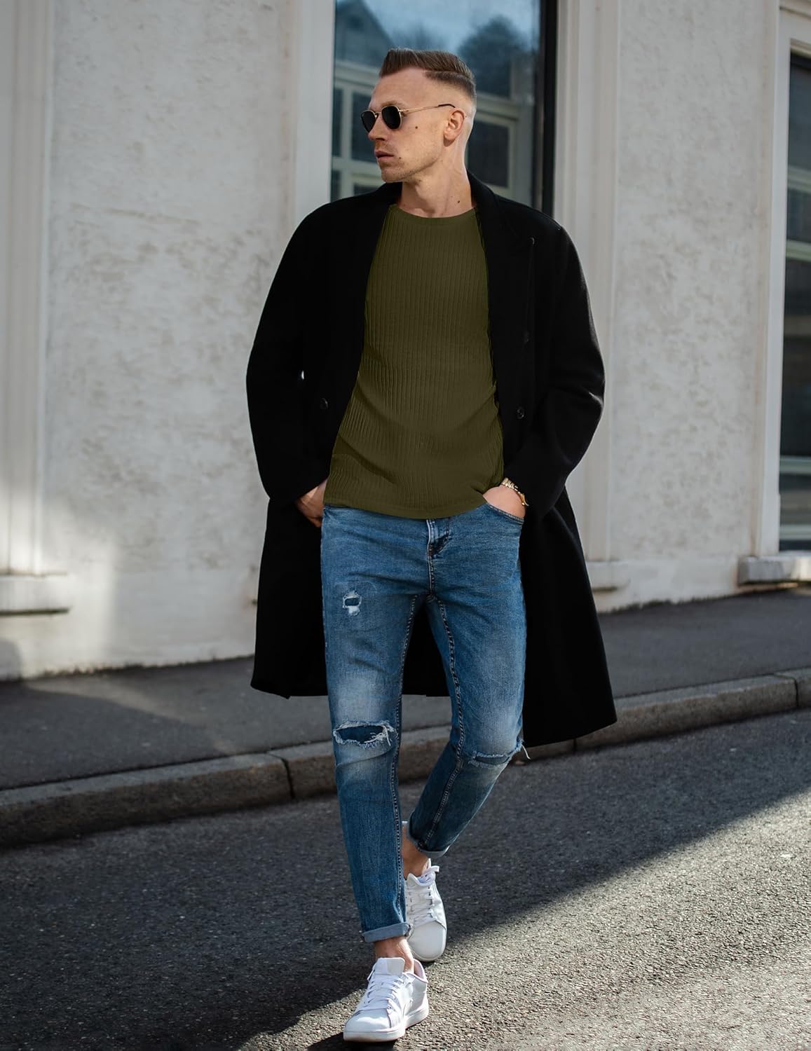 Olive green ribbed long-sleeve sweater under an open black coat
