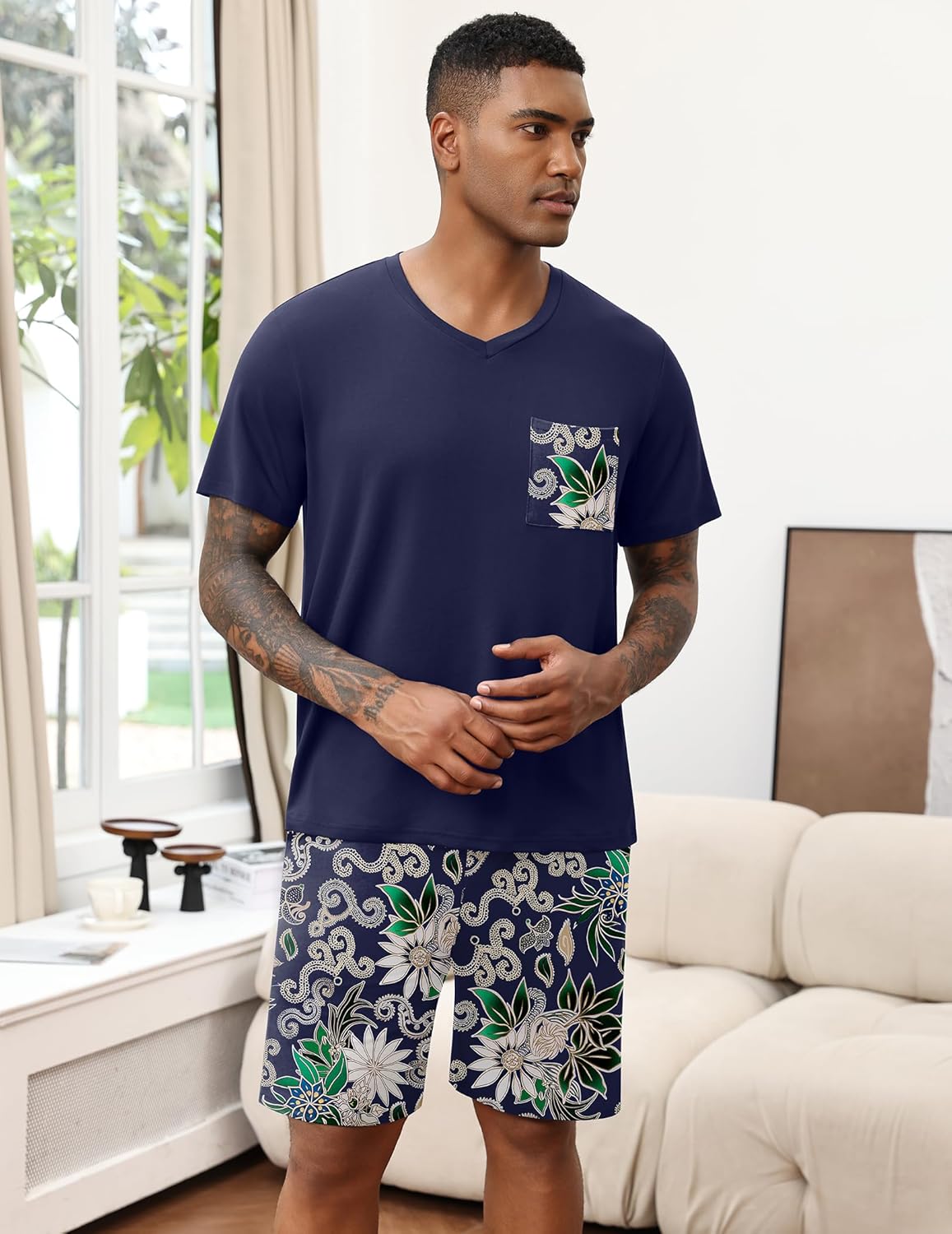 Navy men's V-neck pajama set with decorative chest print and floral shorts.