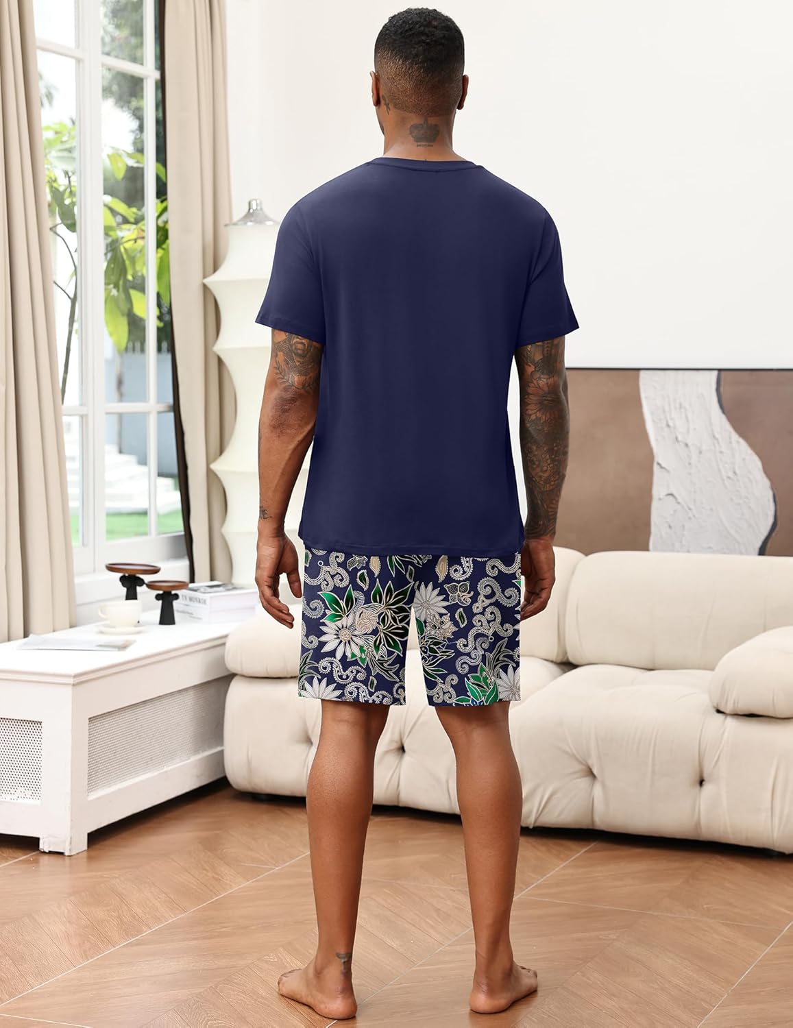Navy men's pajama set, back view, V-neck top and floral patterned shorts.