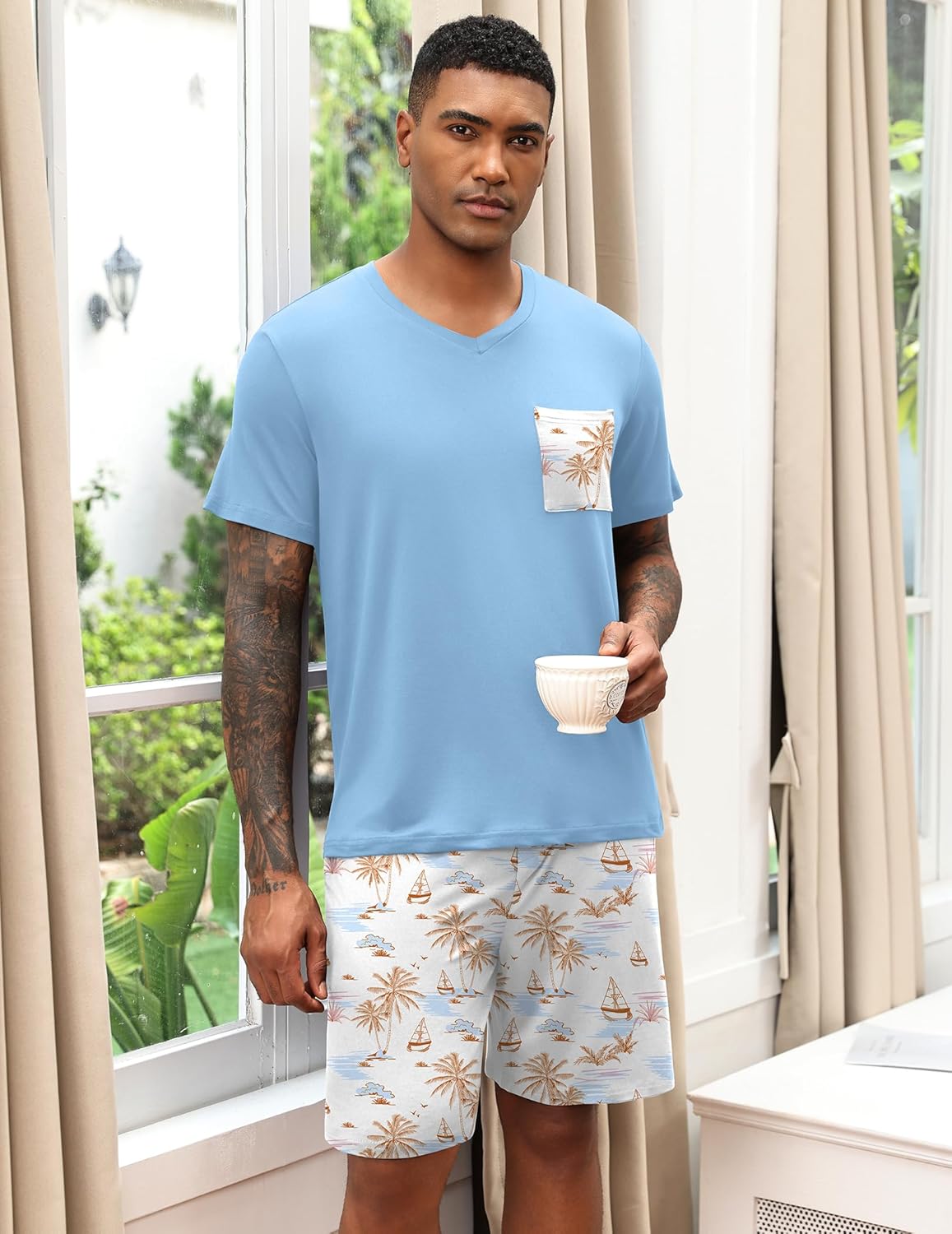 Light blue V-neck pajama set with pocket palm print and matching patterned shorts