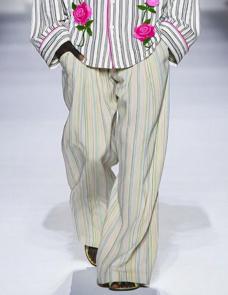 Men's striped pajama set: cream striped pajama pants under rose-embroidered shirt hem.