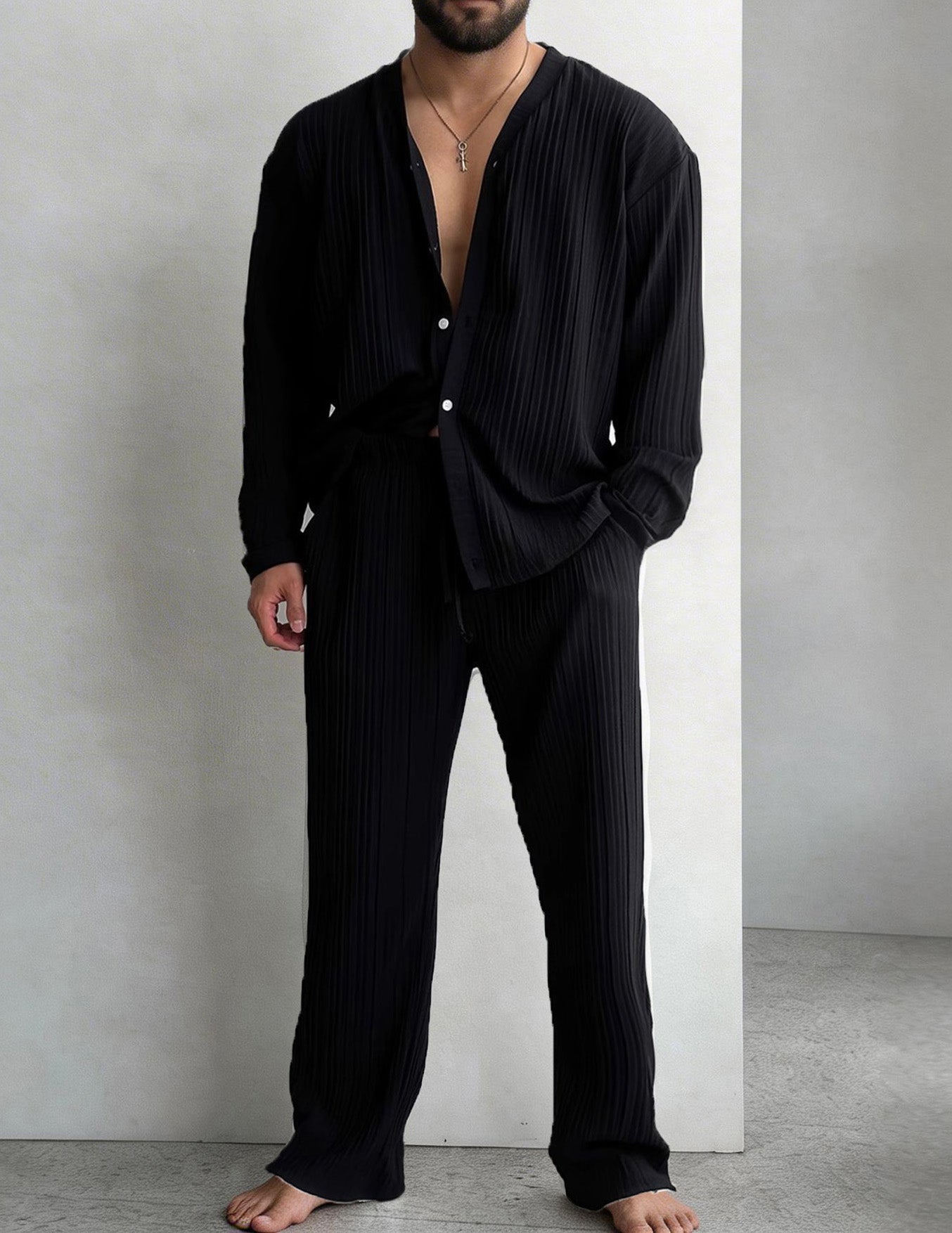 Men's black pleated shirt and pants set with button front and wide trousers