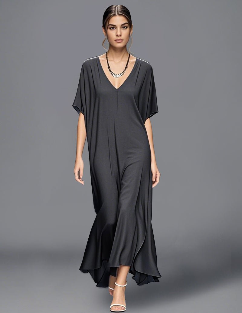 Black minimalist flowy maxi dress with V-neck, short cape sleeves, draped asym hem