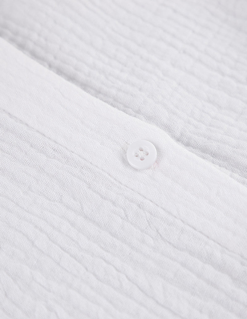 White cotton shirt front with round buttons and textured weave