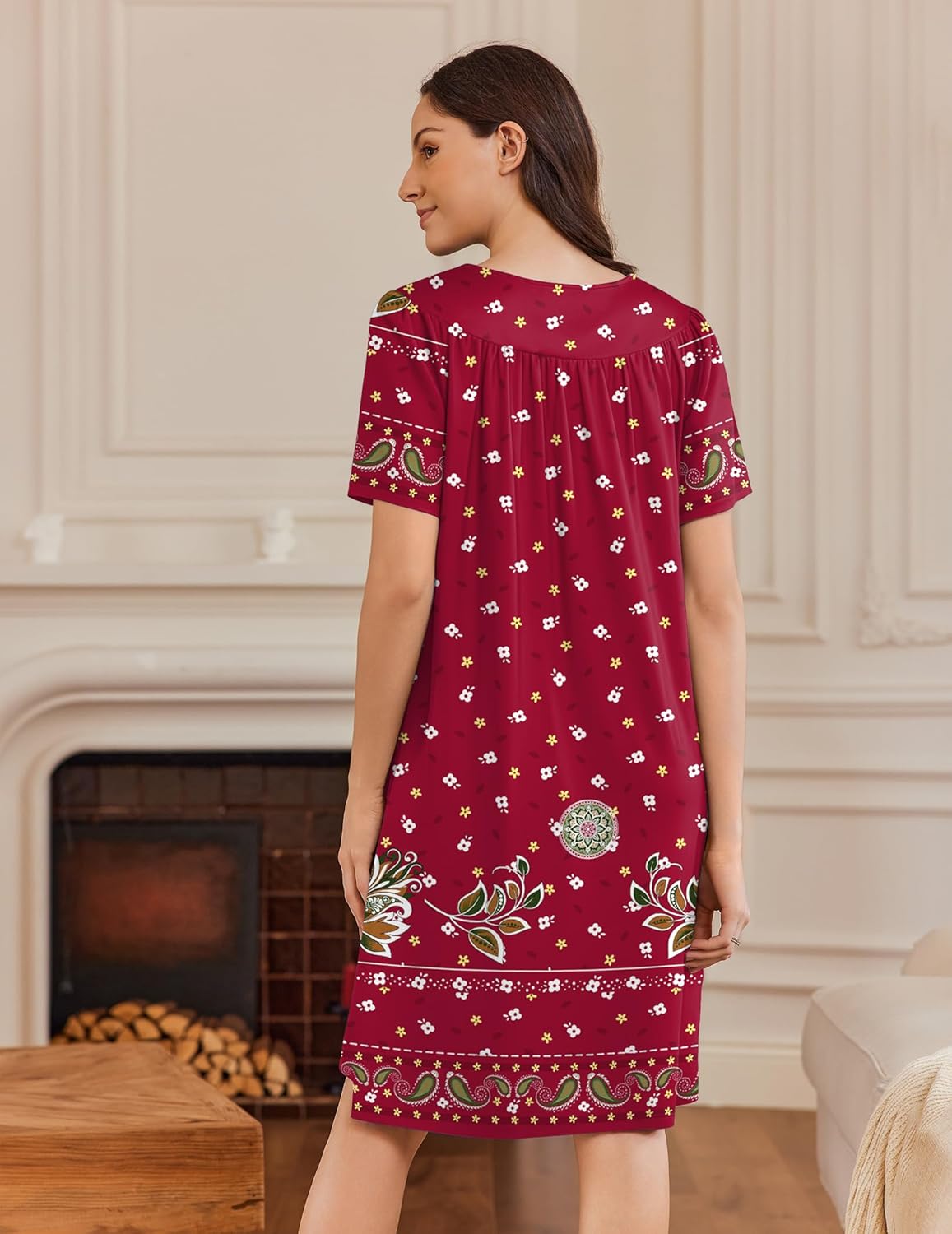 Red button-front house dress, short sleeves, side pockets, allover print, back view.