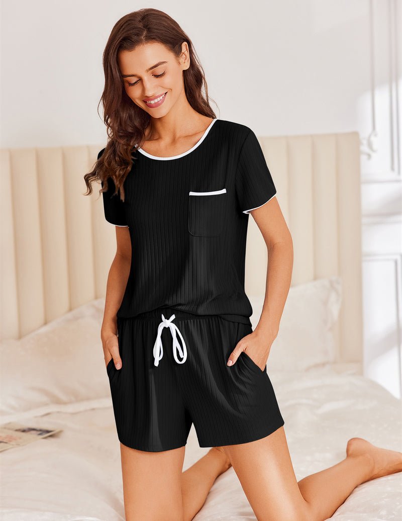 Black ribbed knit pajama set with short sleeves, chest pocket, and drawstring shorts with tie