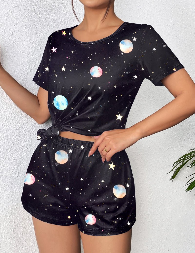 Black short-sleeve pajama top and shorts with colorful planet and star print