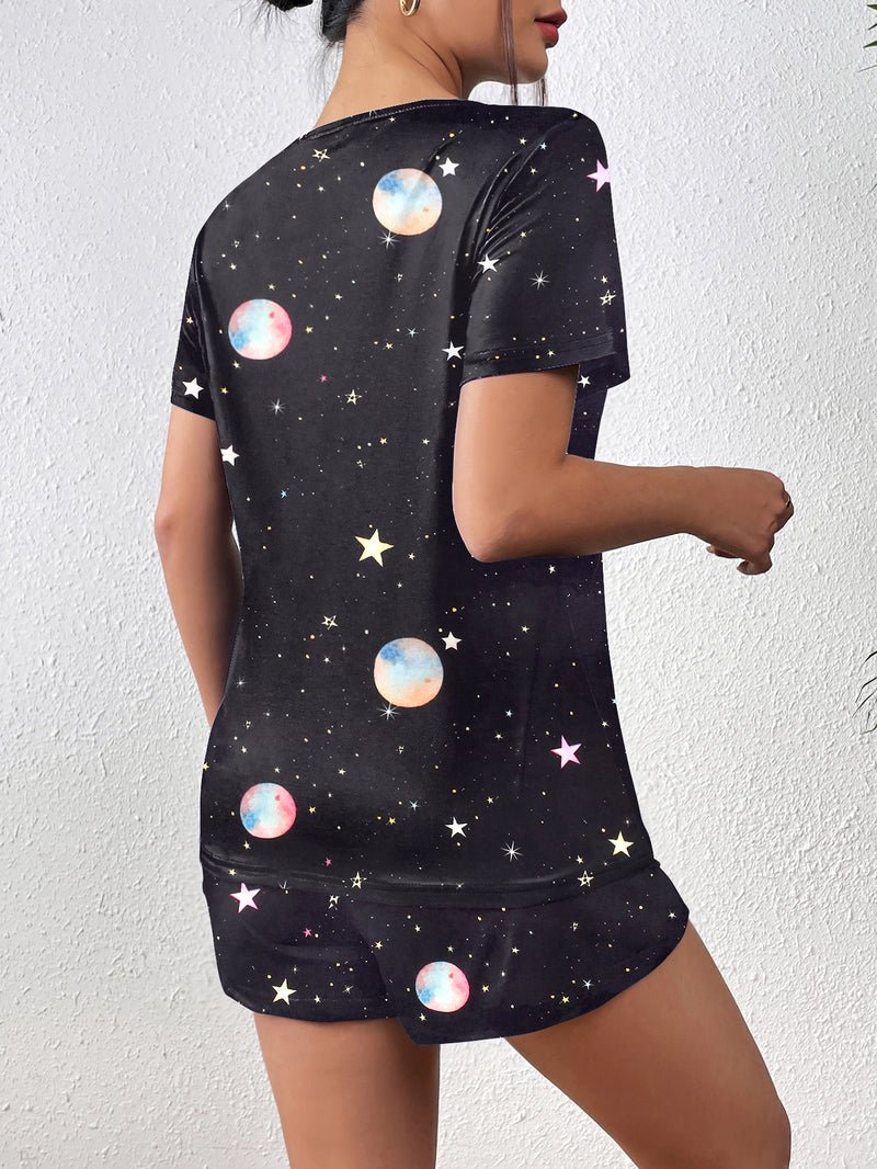 Dark pajama set with planet and star print, short-sleeve top and matching shorts