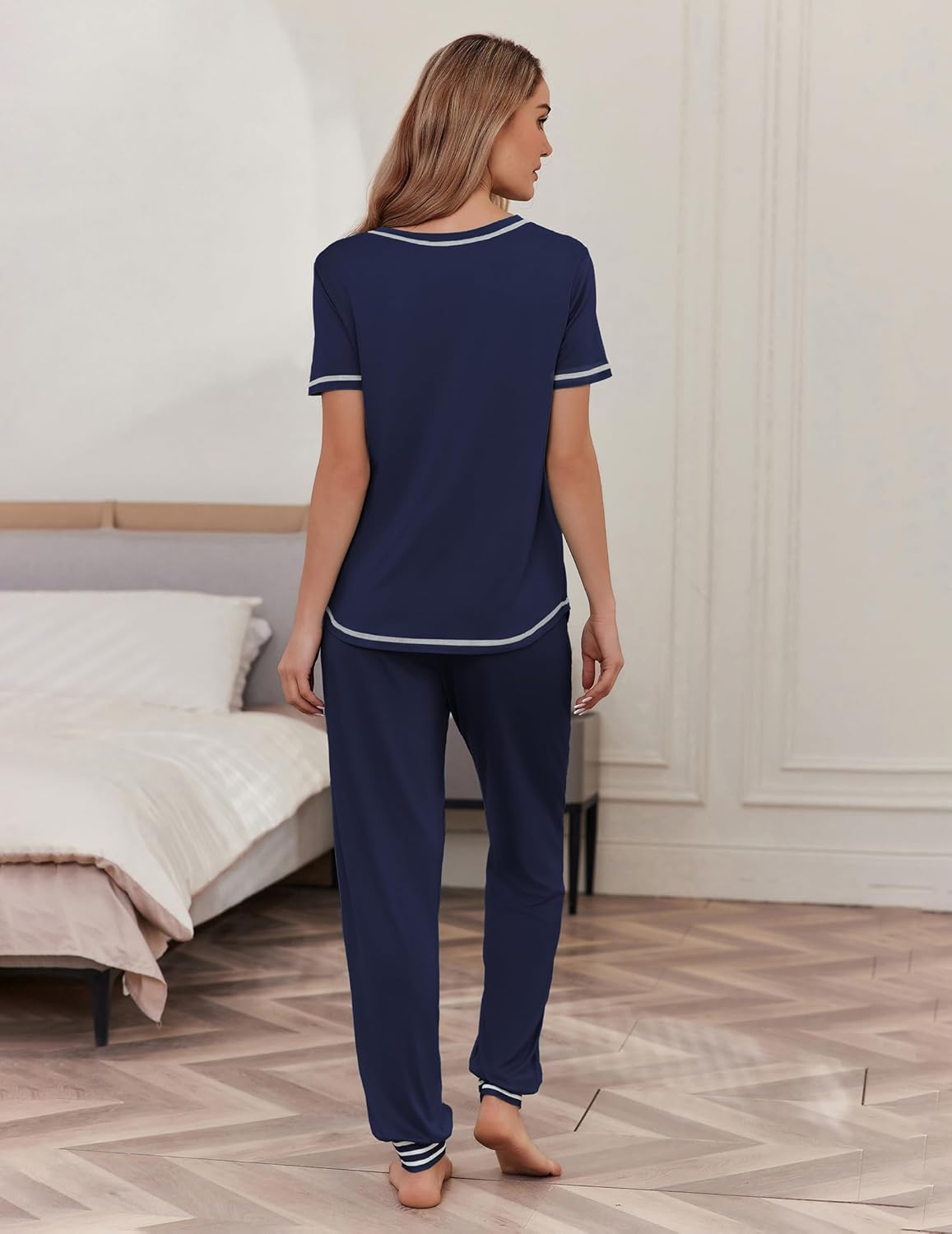 Navy blue pajama set from the back: short-sleeve top with white trim and long jogger pants