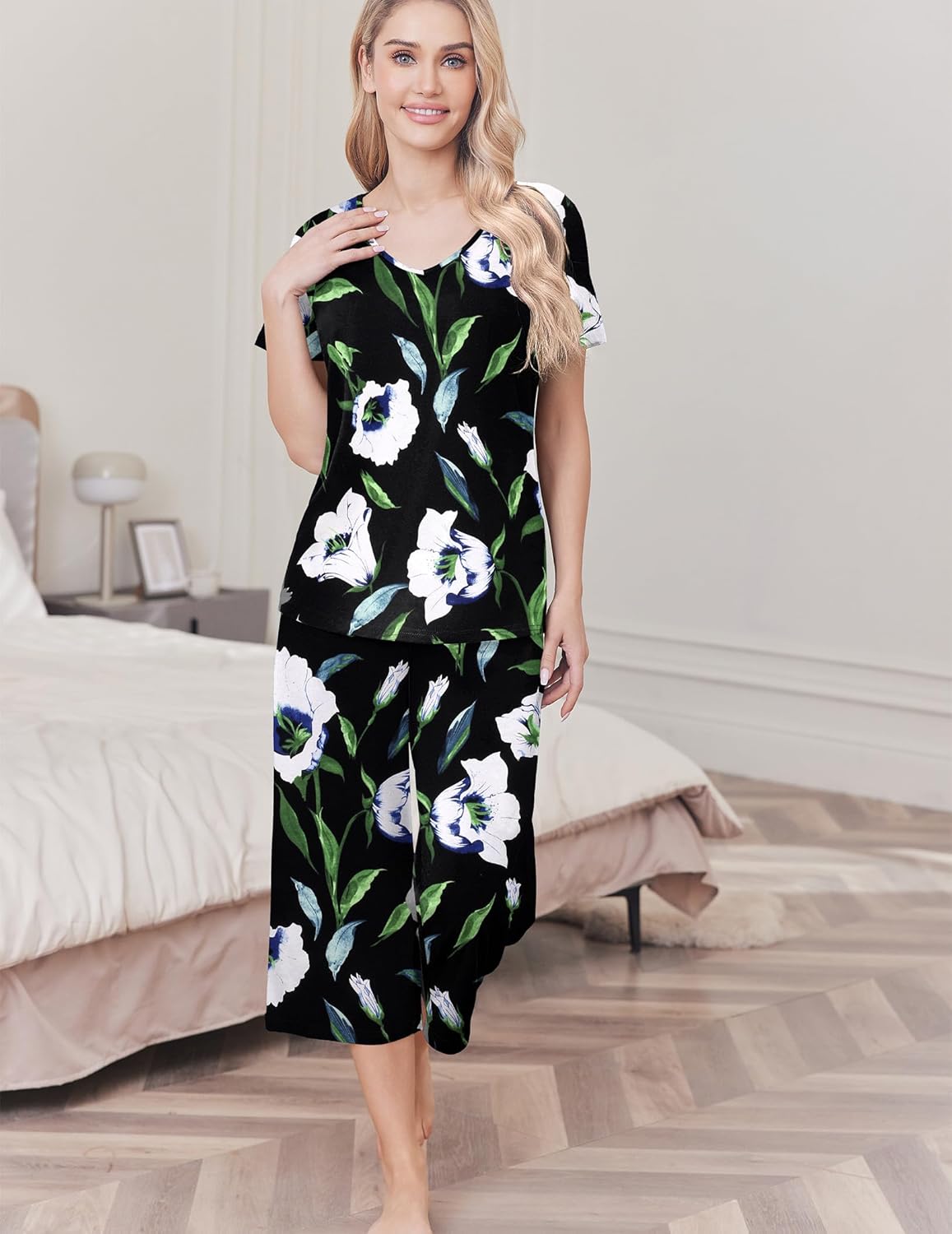 Women's cotton pajama set with black top and capri pants, bold white flower print