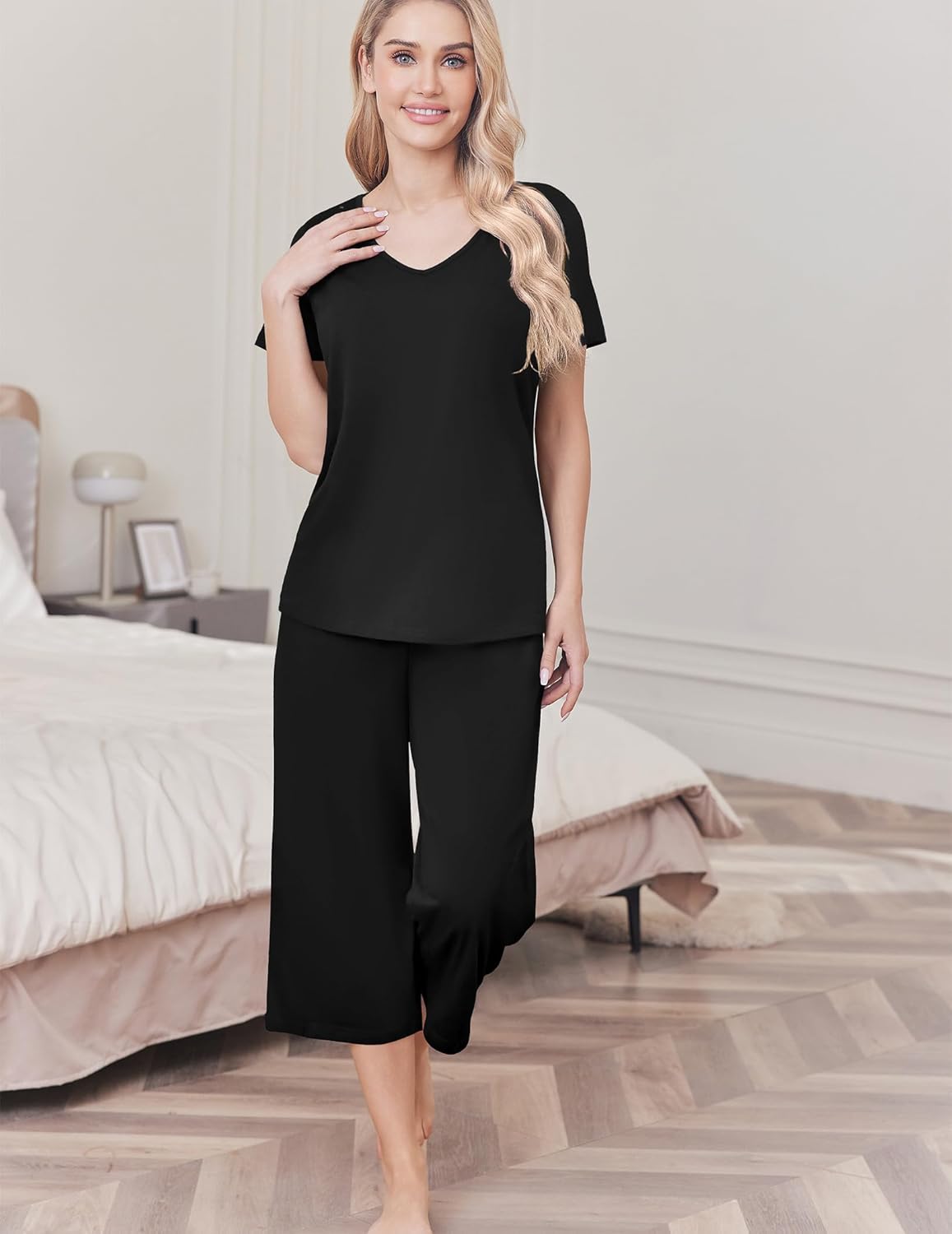 Women's cotton pajama set with solid black top and capri pants, short sleeves